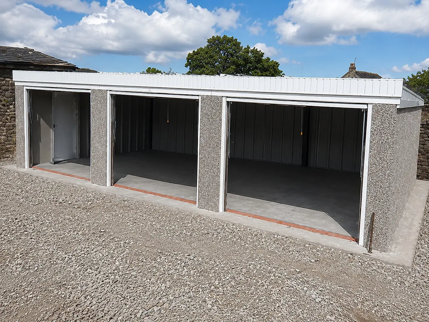 Open concrete battery garage bays showing the lined interiors and a steel personnel door