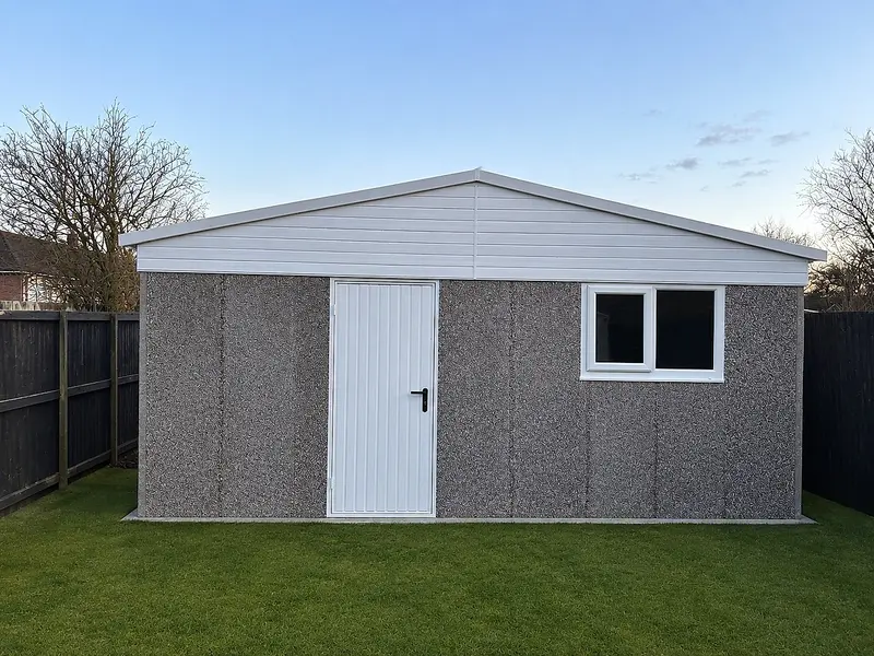 Extra-height apex concrete garage with a raised ridge, personnel door and uPVC window