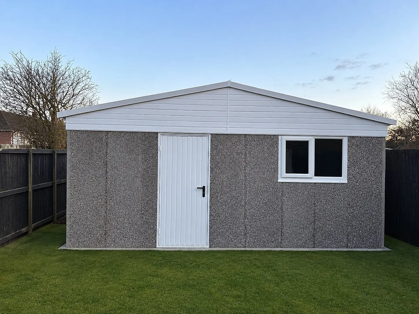 Extra-height apex concrete garage with a raised ridge, personnel door and uPVC window