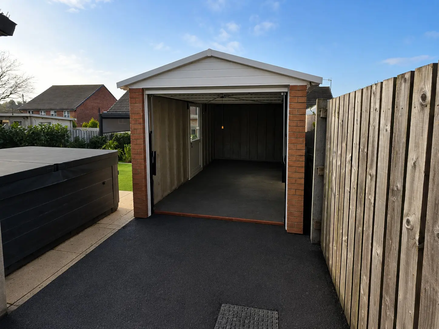 Elite apex concrete garage with a brick front and timber fascia on a tarmac driveway